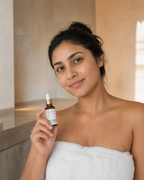 Woman holding Melissa Alchemy Serum Alchemy with Willow Bark, representing a simple daily skincare ritual.